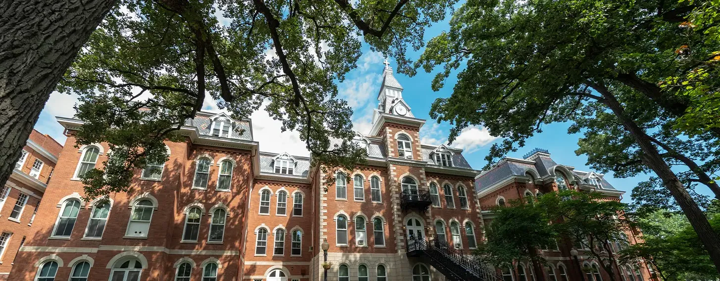 A photo of the beautiful and historic Ambrose Hall, a large brick building with a clock tower.